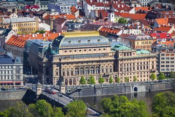 Fototapeta na wymiar View of the Prague National Theater on a bright sunny day along the Vltava River, Czech Republic