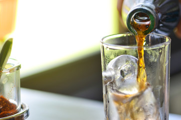 Cola drop in glass on holliday time