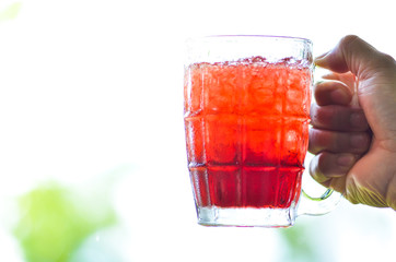 Red water and ice in a glass