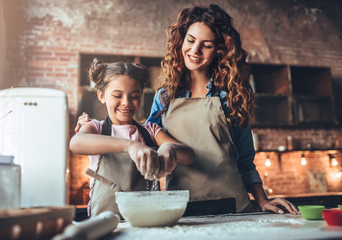 Mom with daughter on kitchen.