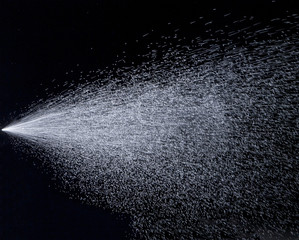 Water jet spraying on black background