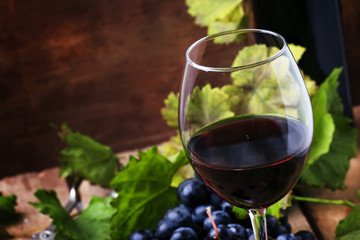Spanish red dry wine from rioja vine, vintage wooden background, selective focus