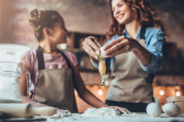 Mom with daughter on kitchen.