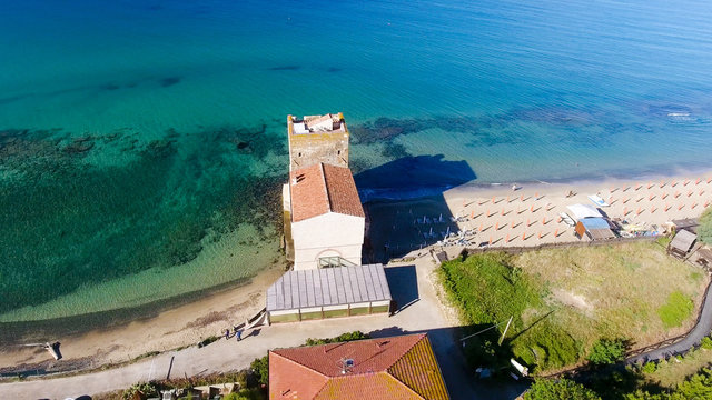 Ancient tower in front of the ocean, aerial view