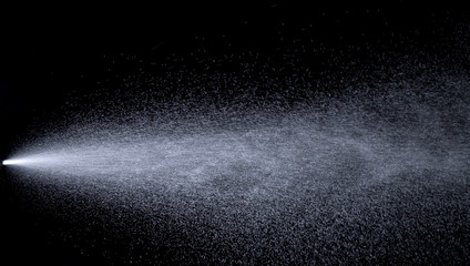 Water jet spraying on black background