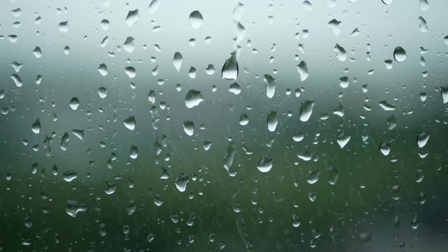 4K. rain running up on window surface. rain drop in rainy day