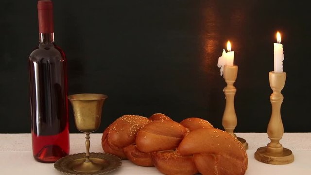 shabbat footage. challah bread, shabbat wine and candles on the table