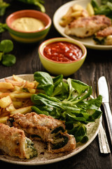 Pork roulades with spinach and cheese filling, served with fried potatoes.