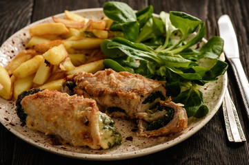 Pork roulades with spinach and cheese filling, served with fried potatoes.