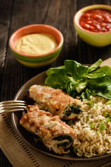 Pork roulades with spinach and cheese filling, served with brown rice.
