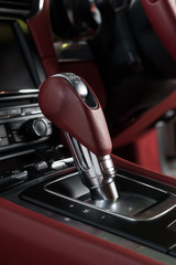 Fototapeta na wymiar Car detailing series: Closeup of transmission stick in luxury car