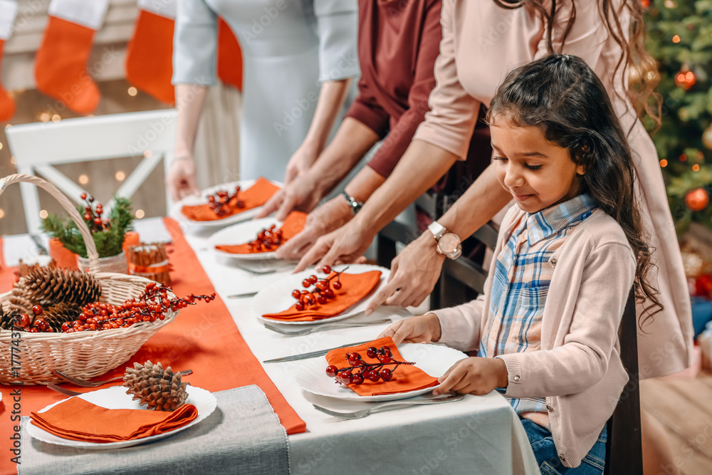 Wall mural girl decorating christmas table