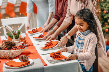girl decorating christmas table