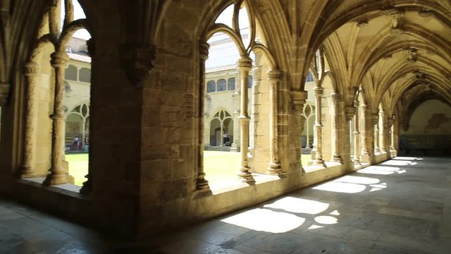 POV in colonnade of gothic romanesque cloister of old Cathedral of Coimbra. Se Velha de Coimbra, one of important romanesque buildings in Portugal and a popular landmark in Coimbra, northern Portugal