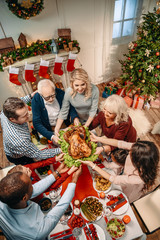 large family holding christmas turkey