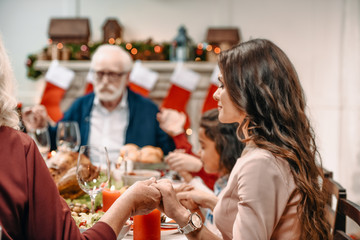 family praying before christmas dinner