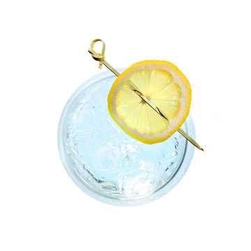 Glass Gin And Tonic Cocktail With Lemon Slice Isolated On A White Background. Top View.