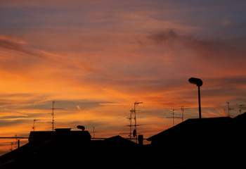 Rooftops view under sunset sky