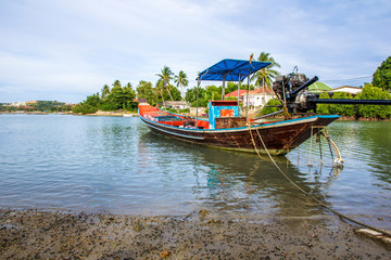 Long-tail boat of local Thai fisherman parked in the bay.