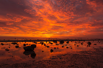 Fototapeta na wymiar Sunset view by the sea, orange sky, beautiful clouds.