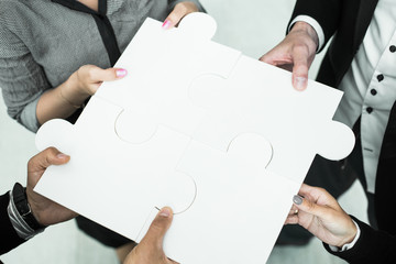 Hands holding puzzle