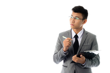 Portrait of a young business man writingl report. Isolated on white background