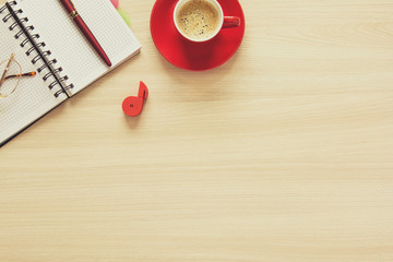 Top view on work table. Coffee cup, tablet, glasses, notes and pen. Flat lay