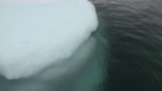 People rubber boatt in ice on water surface of Antarctica Ocean. Unique landscape of nature. Quiet and calm wilderness ecotourism. Wildlife on background of white snow coast desert.