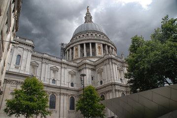 St Pauls Cathedral under dark clouds seen from below