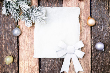 Christmas Greeting card with red ball and christmas tree on wooden background. Top view.