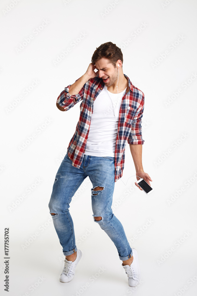 Canvas Prints Full length portrait of a cheery young man with earphones