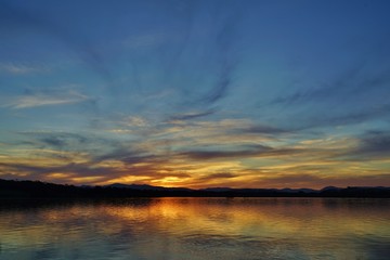 Fototapeta na wymiar Dramatic orange sunset of the Lake Burley Griffin in Canberra, ACT, Australia