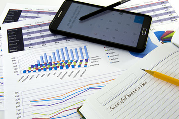 Business graphs and charts report with pen on desk of financial advisor. Financial accountancy Concept.