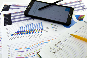 Business graphs and charts report with pen on desk of financial advisor. Financial accountancy Concept.