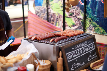 Grilled sausage on a grill at a market in Camden