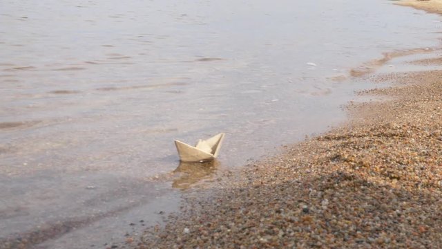 White Paper Ship is Floating by Watery Surface. the Flotilla of Paper Ships. Childish Amusement, Playing Game. Hope For Survival. Childish Dream. the Lonely Sail is Showing White. Loneliness,