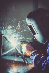 Welding steel pipe and producing sparks. - obrazy, fototapety, plakaty