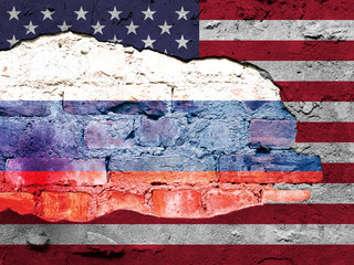 American flag and Russian flag painted on a brick wall. 