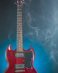 Fototapeta premium electric guitar in smoke, blue background
