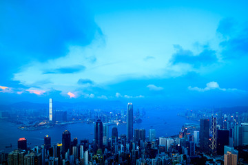 Hong Kong skyline and Victoria harbor. View from the Peak at twilight dusk