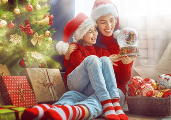 Mom and daughter near the Christmas tree