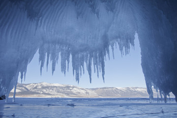 Icicles in cave. Lake Baikal. Winter landscape