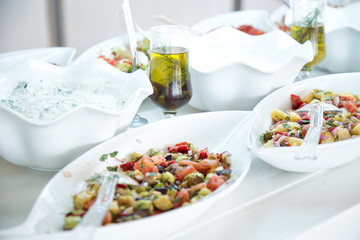 Vegetable  salads with olive oil  in white plates