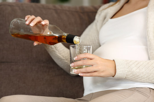 Irresponsible pregnant woman drinking alcohol