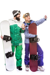 couple with snowboards taking selfie