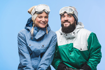 smiling couple in snowboard clothing