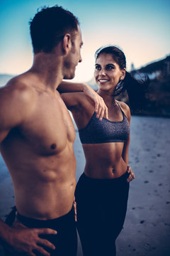 Fit happy caucasian adult couple together on the beach