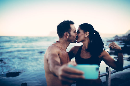 Fit couple taking selfie with smart phone after workout