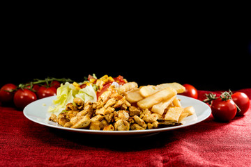 Fresh chicken steak with tomatoes and french fries
