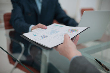 Businessman his colleague giving contract to read and sign